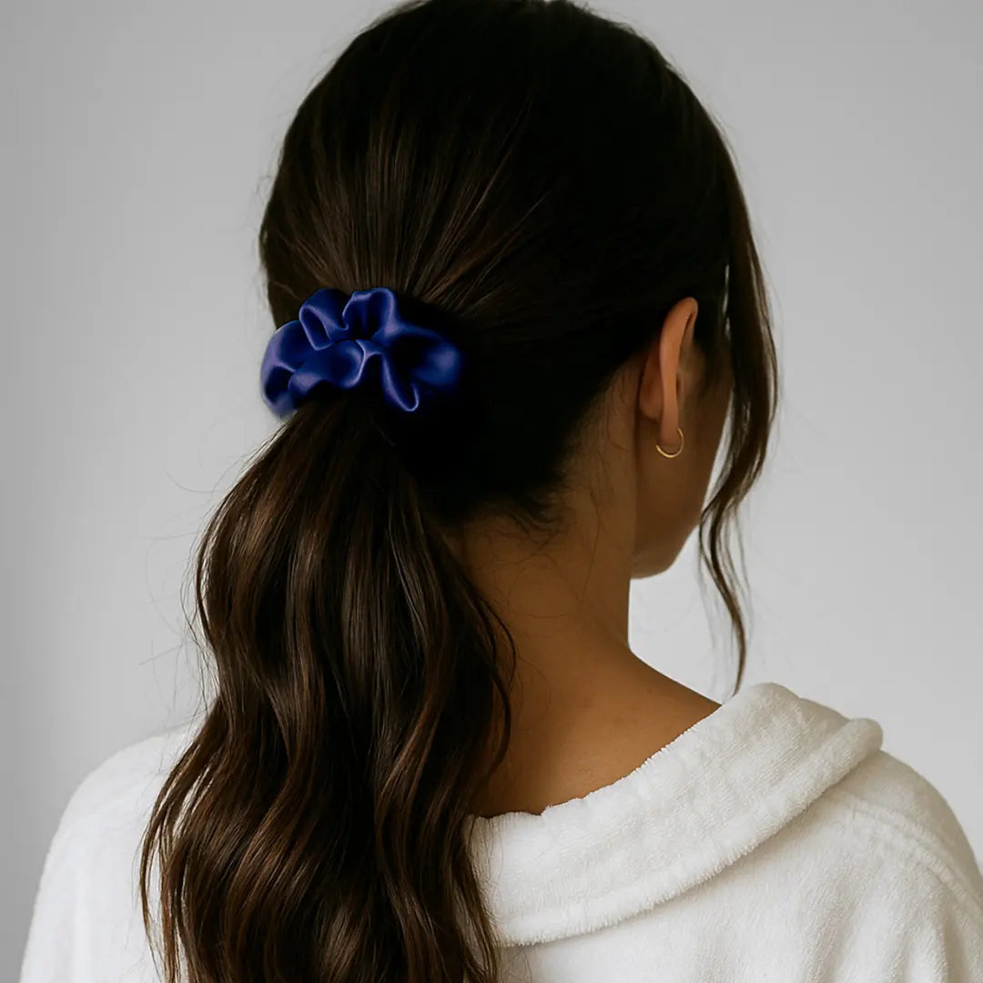 Woman wearing GLOWE Silk Scrunchie in Deep Navy in ponytail, showing gentle hold without hair creasing