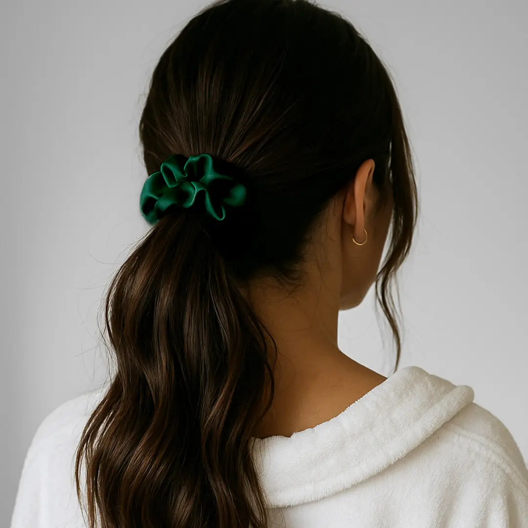 Woman wearing GLOWE Silk Scrunchie in Forest Green in ponytail, showing gentle hold without hair creasing