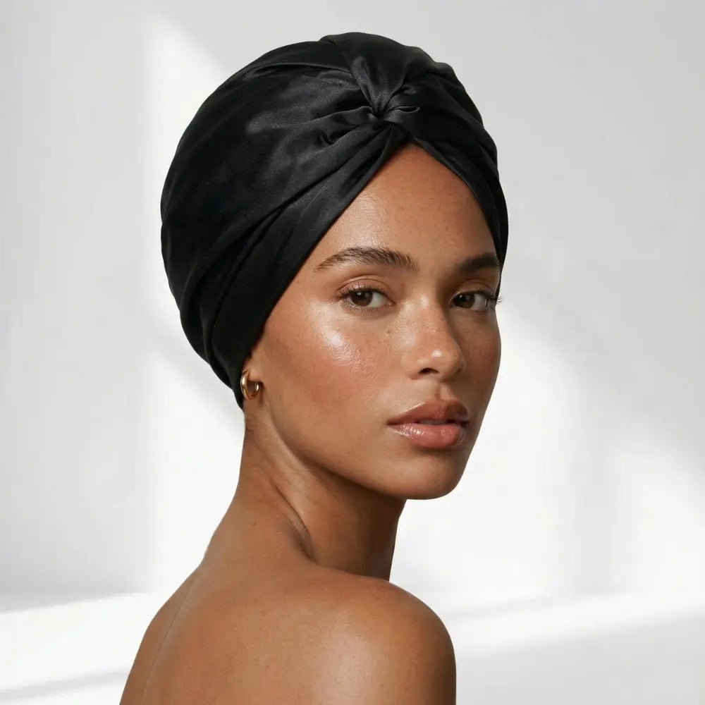 Black silk bonnet on a model looking back