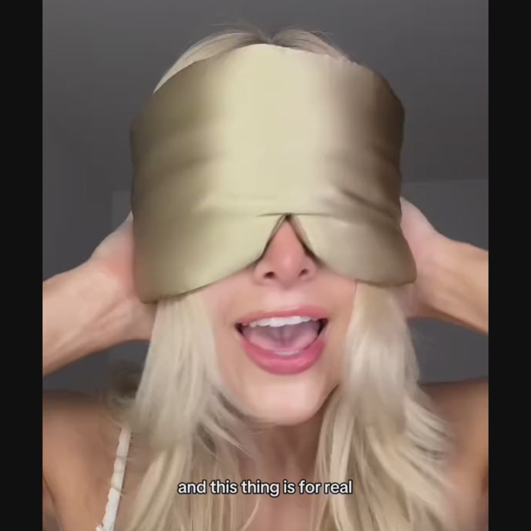 Woman demonstrating how to wear the GLOWE Deep Sleep Mask, showing fit and adjustable strap