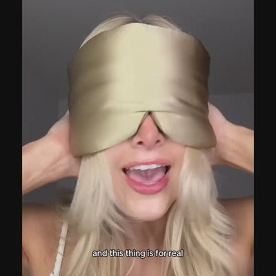 Woman demonstrating how to wear the GLOWE Deep Sleep Mask, showing fit and adjustable strap